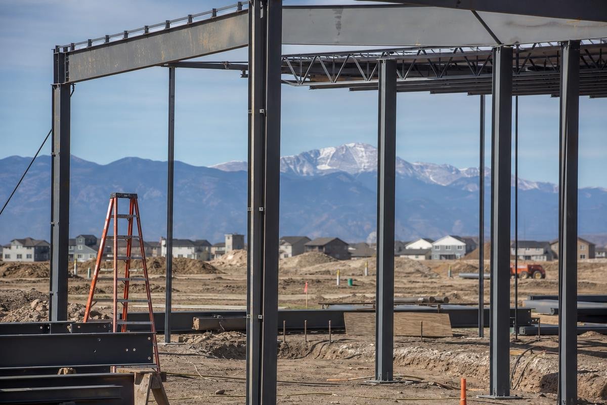 Warehouse construction in Colorado Springs with mountain backdrop showing elevation conditions