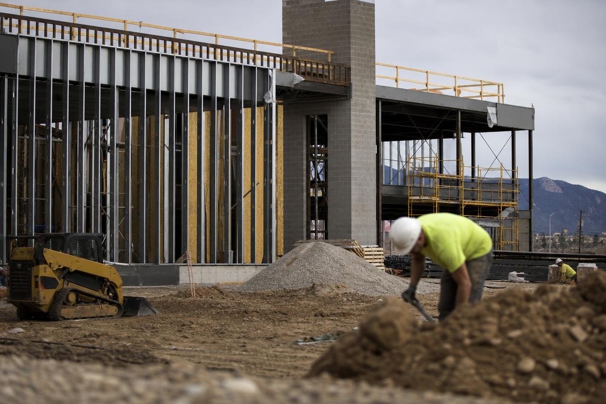 Commercial builders coordinating trades on a Colorado Springs job site